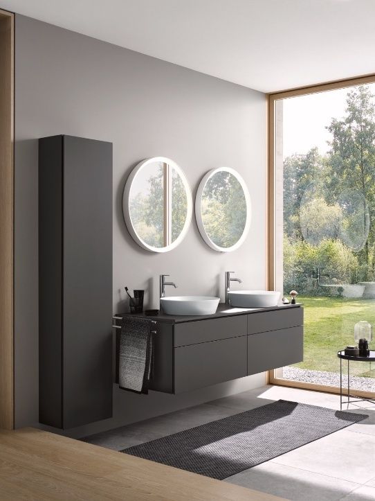 A bathroom with a double sink and round mirrors AI-generated content may be incorrect.